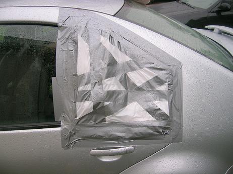 [The temporary plastic bag and duct tape window to make it back home.]