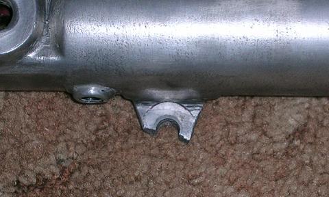[Picture showing the broken caliper mounting lug on the left fork slider.]