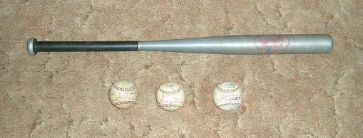 [My three home-run baseballs and the bat that hit them from 1981.]