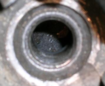 [Looking at the top of the horizontal piston through the spark plug hole.]