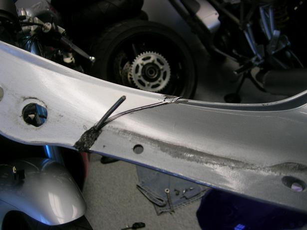 [A piece of filler partially melted into the fairing.]