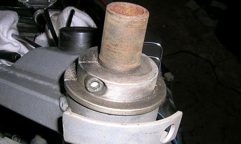 [The special nut that is used to hold the steering stem, bearings, and lower to the bike. The upper triple clamp just attaches to this assembly.]