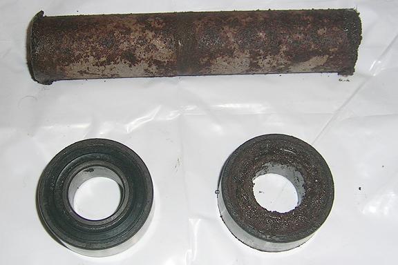 [The wheel bearings from the rear wheel. Notice all the rust on the components. The bearing on the left shows the side that was facing outward after it was cleaned a little.]